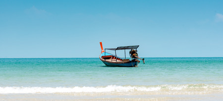 single fishing boat in blue seaの写真素材