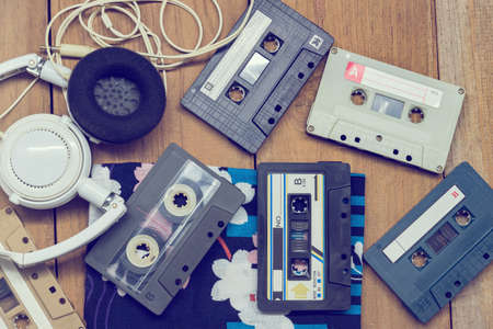 Top view Cassette tape and head phone laying on wood boardの写真素材