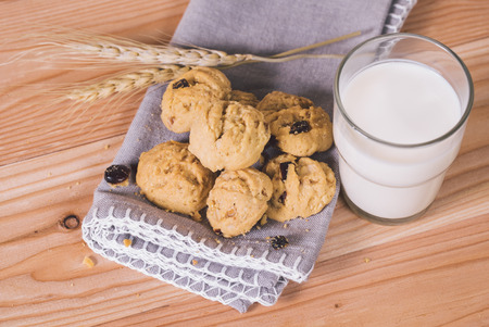 Currant Cookies on wood table with glass of milk , homemade food.の写真素材