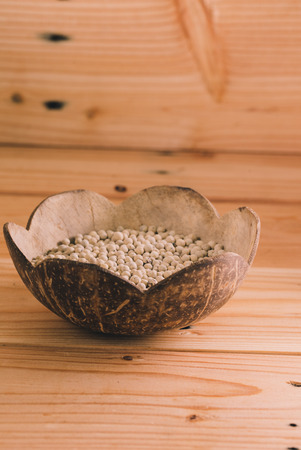 Close-up shot pepper with wood spoon on wooden backgroundの写真素材