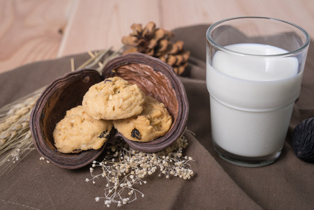 Currant Cookies on wood table with glass of milk , homemade food.の写真素材