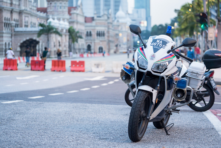 Kuala Lumpur, MALAYSIA  May 20 2016 - Police motorcycles on a city sidewalk prepare to leave after several officers questioned a man.のeditorial素材