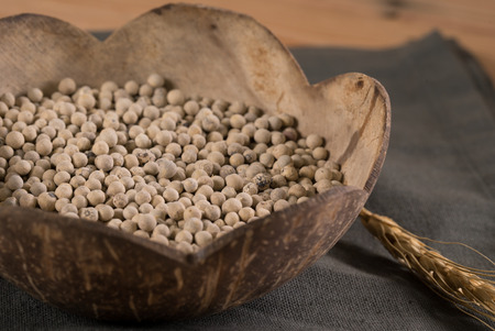Close-up shot pepper with wood spoon on wooden backgroundの写真素材