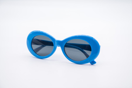 Fashionable blue sunglasses isolated on whiteの写真素材