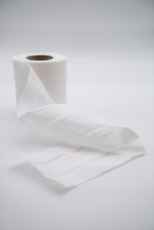 white toilet paper roll in closeup isolated on a white background.の写真素材