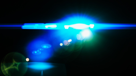 Realistic Len flare glow light effect on black background. Optical flares overlay or screen filter matte.の写真素材