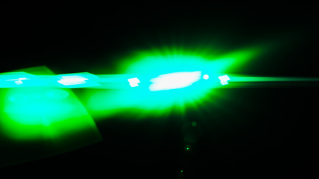 Realistic Len flare glow light effect on black background. Optical flares overlay or screen filter...