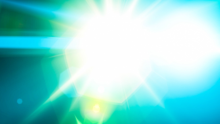 Realistic Len flare glow light effect on black background. Optical flares overlay or screen filter matte.の写真素材