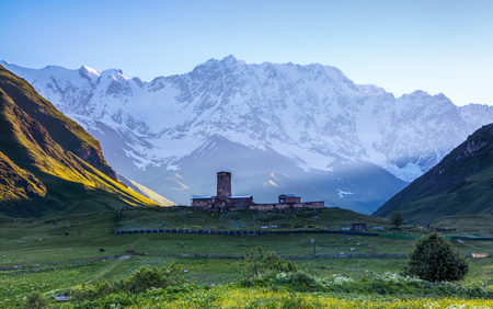 A fascinating view on Ushguli village at the foot of snow-capped Mt. Shkhara. Location place Lamaria Church Jgrag, Upper Svaneti, Georgia, Europe. Happy lifestyle. Beautiful universe.の写真素材
