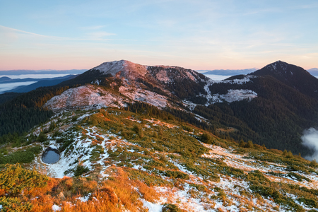 From the valley covered with snow the fantastic panorama is opened to high mountains, lake and fog in autumn morning.の写真素材