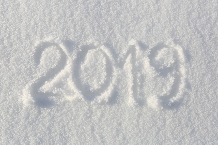 2019. Writings on the snow. Happy new year. Beautiful cold sunny winter day.の写真素材