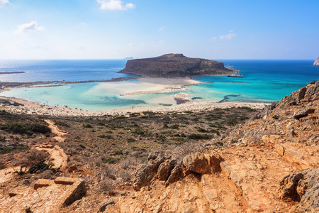 Marvelous landscape of a rocky hill, Balos beach with fantastic white sand and three seas: Ionian, Aegean and Libyan. Great summer day. Popular touristic resort, coast of island Crete, Greeceの写真素材