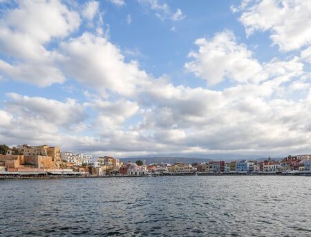 The city of Chania is a port on the west coast of the Cretan Sea in Greece. A tourist attraction, a long quay, interesting architecture, a Turkish bath building, houses. Mountains on the horizon.の写真素材