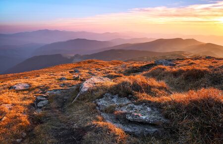 Panorama with interesting sunrise enlightens surroundings. Landscape with beautiful mountains and...