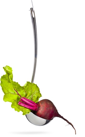 Fresh beet in the ladle,hanging,isolated on whiteの写真素材