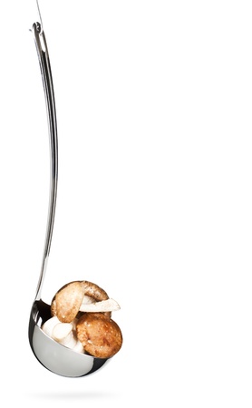 Fresh mushrooms in the ladle,hanging,iasolated on whiteの写真素材