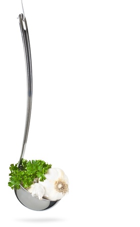 Fresh garlic and parsley in the ladle,hanging,isolated on whiteの写真素材