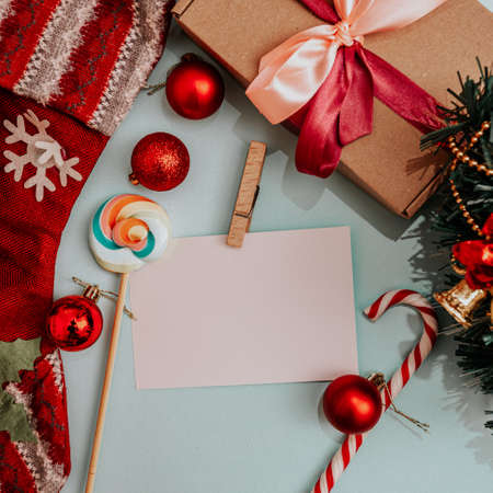 white sheet for inscriptions, candies, gifts, Christmas toys on a blue background
