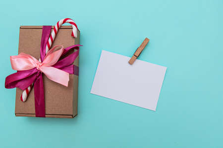 white sheet for an inscription and a New Year's gift on a blue backgroundの写真素材
