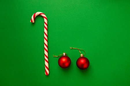 Christmas toys and candies on a green background