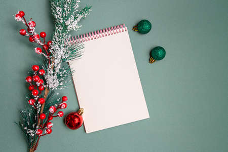christmas tree branch with toys and blank notepad for inscriptions