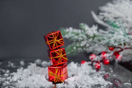 christmas ball, small gifts on gray blurred background, christmas decoration