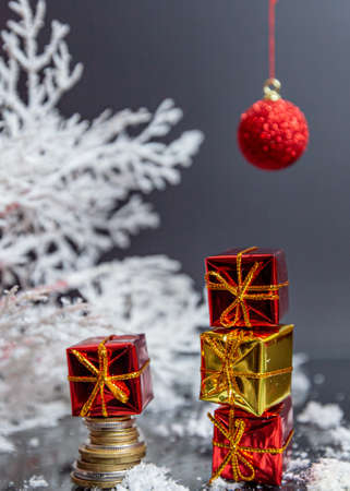 coins, christmas ball, small gifts on gray blurred background, christmas decorationの写真素材