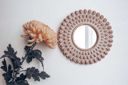 decorative mirror and yellow flower on a white wall. home decorの写真素材