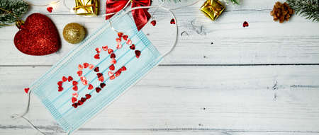 medical mask with numbers 2021 and Christmas decorations. christmas concept to coronavirus. High quality photo bannerの写真素材