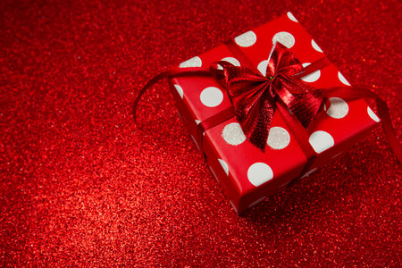 polka dot gift box on red background, happy valentines day . High quality photo