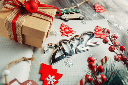 Christmas background of flatlets with a gift, and Christmas decorations on a wooden background....