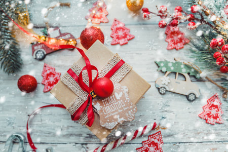 gift box and Christmas decorations on a wooden background with snowflakes and a garland. new year concept. . High quality photoの写真素材