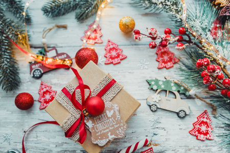 gift box and Christmas decorations on a wooden background with snowflakes and a garland. new year concept. . High quality photoの写真素材