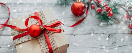 gift box and Christmas decorations on a wooden background with snowflakes. High quality photoの写真素材