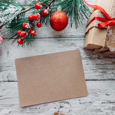 Christmas decorations, gifts with a craft card for inserting text on a wooden background with snowflakes. High quality photoの写真素材