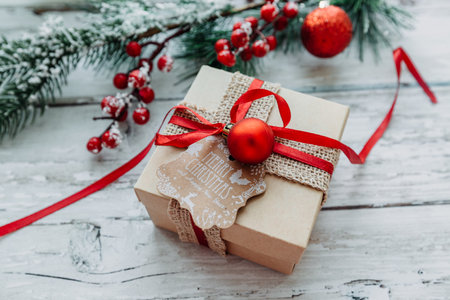 gift box and Christmas decorations on a wooden background with snowflakes. High quality photoの写真素材