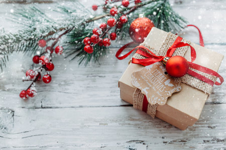 gift box and Christmas decorations on a wooden background with snowflakes. High quality photoの写真素材