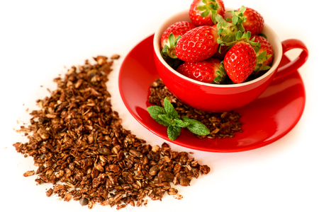 Fresh strawberries in a red bowl and chocolate granola isolated on white background. Horizontal. Above view.の写真素材