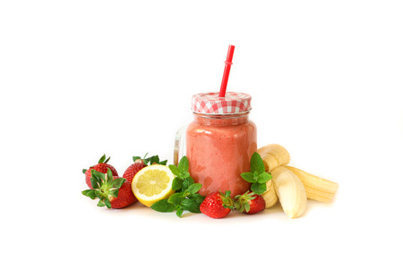 Strawberry smoothie with banana, lemon and mint leaves on a white background isolated. Superfood, detox and healthy food concept. Horizontal.の写真素材