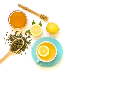 Cup of green tea with lemon and ingredients isolated on white background. View from above.の写真素材