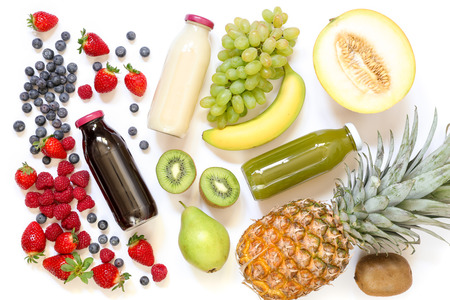 Three different types of fresh juices or smoothies in bottles and ingredients isolated on white background.の写真素材
