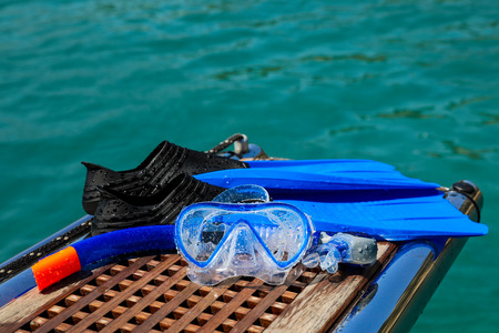 Mask and fins on the sea background, active rest by the sea concept.