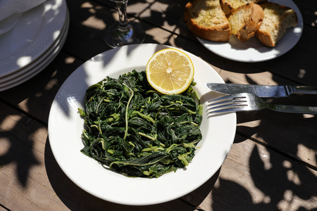 Cooked greens salad in greek tavern.の写真素材