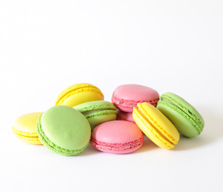 Three different types of macaroons colors pink, green and yellow isolated on white background. Close-up.の写真素材