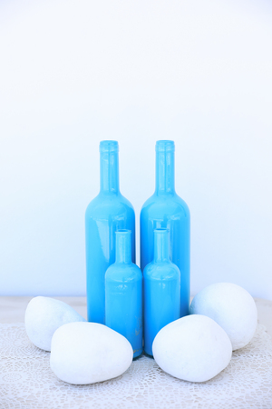 Different sizes four blue bottles as a vase idea for your home in Mediterranean style. Vertical. Close-up.の写真素材