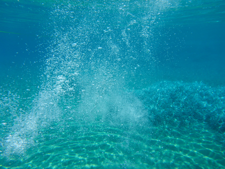 Abstract background of underwater bubbles snorkeling in Kolona double bay Kythnos island Cyclades Greece, Aegean sea. Horizontal.の写真素材