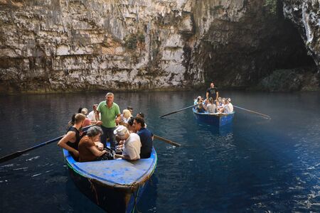 During summer vacation tourists make an excursion in the boats on the lake of Melissani Cave located on the island of Kefalonia, northwest of Sami town, Ionian Islands region, Greece. Horizontal.のeditorial素材