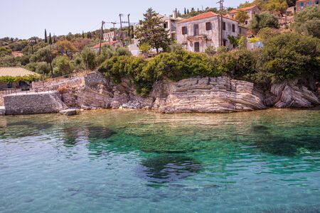 Kastos island summer picturesque nature with turquoise crystal clear water, rocks, green trees, old...