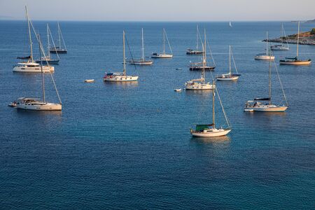 Anchored sailboats off the coast of Kastos island, Ionian sea, Greece in summer.の写真素材