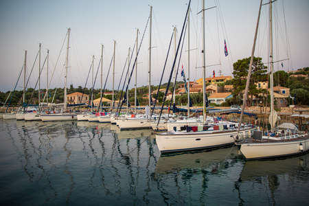 KASTOS island, GREECE-August,2019: Port of Kastos island with moored sailboats - Ionian sea, Greece in summer.のeditorial素材